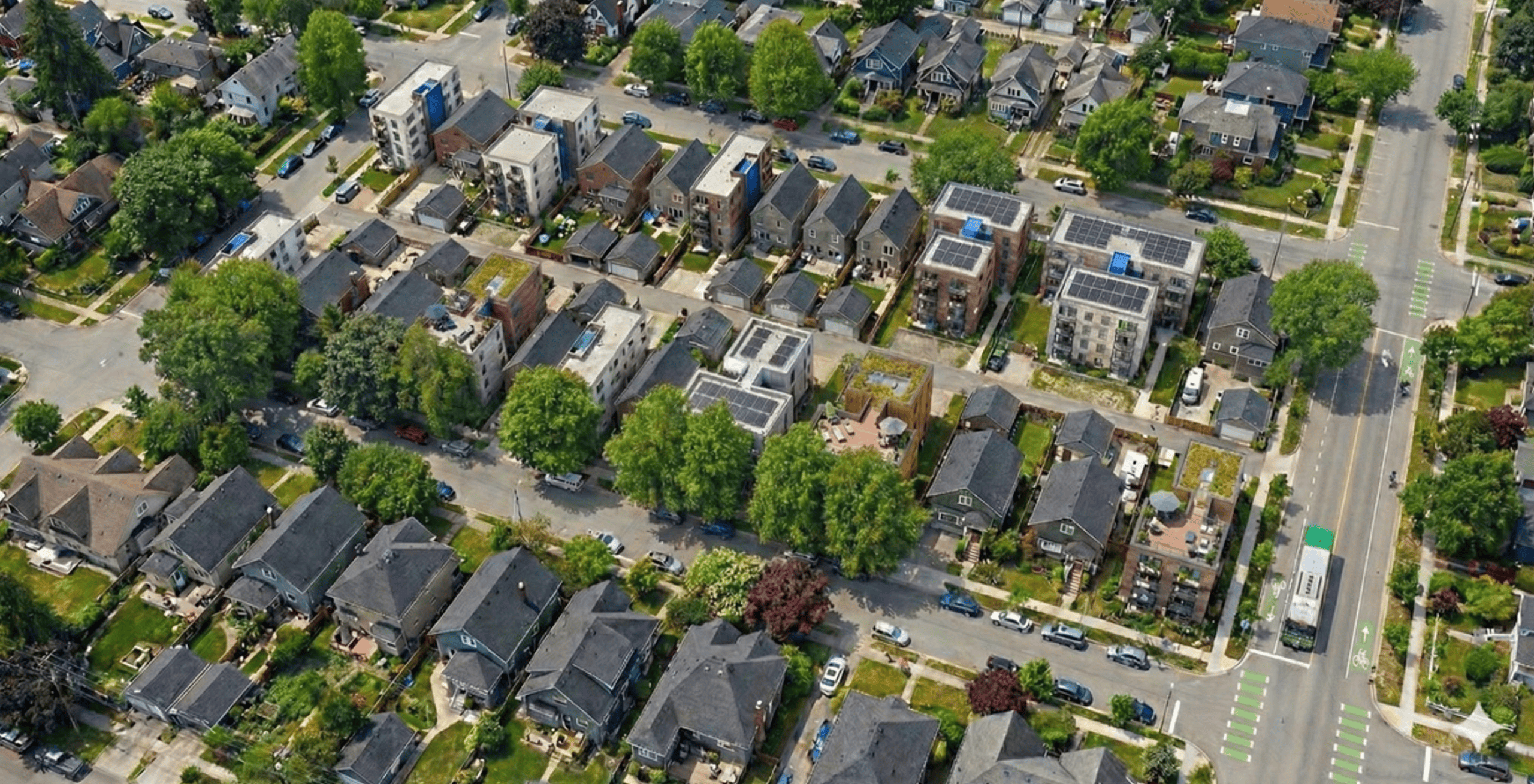 A variety of small-lot, single-stair buildings interspersed with single-detached homes on standard lots in Vancouver (frontages of 33, 50, 66, and 100 feet), with lanes and alleys.  