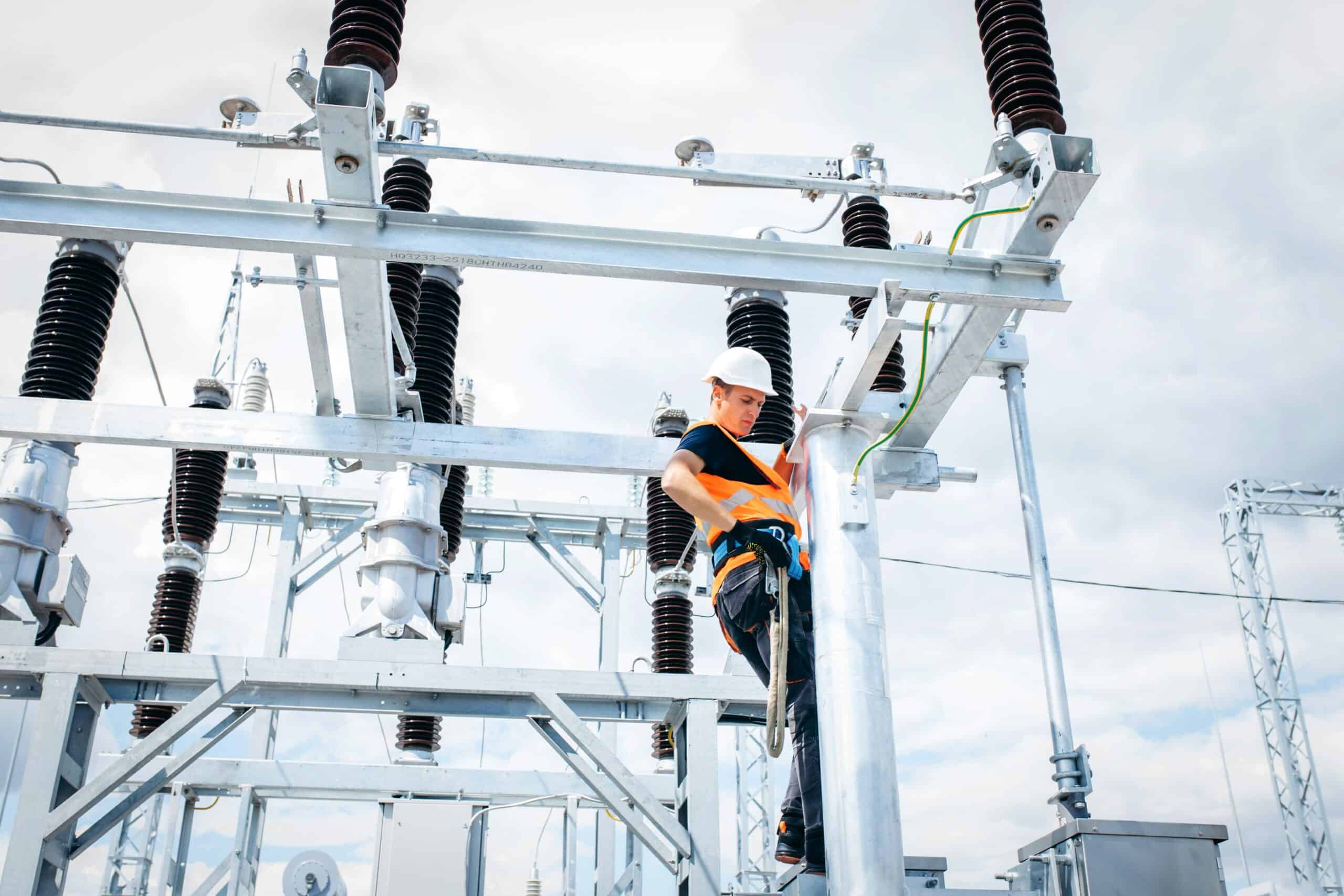  An electrician services a high-capacity transmission station.