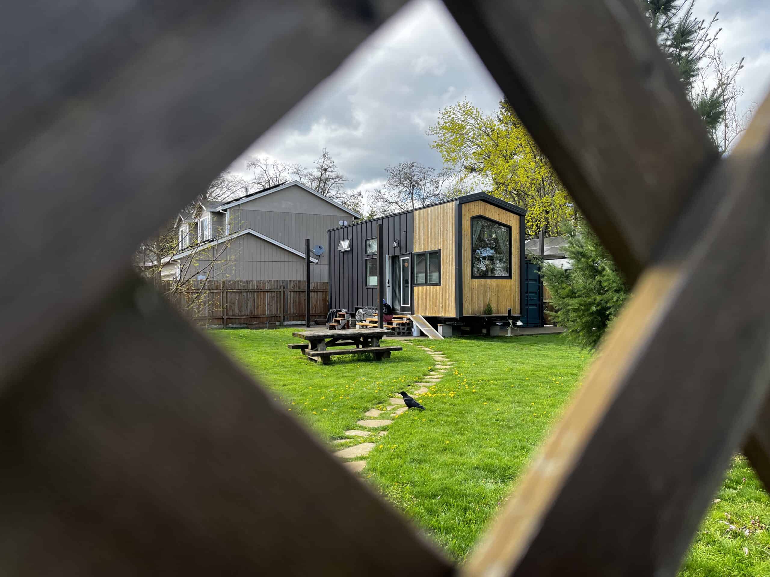 A tiny home on wheels (THOW) on a residential lot in the Cully neighborhood of Portland, Oregon. This particular home was installed after the city legalized living in mobile dwellings in 2021, opening up a low-cost, flexible, and speedy housing option for locals. Photo by Catie Gould.