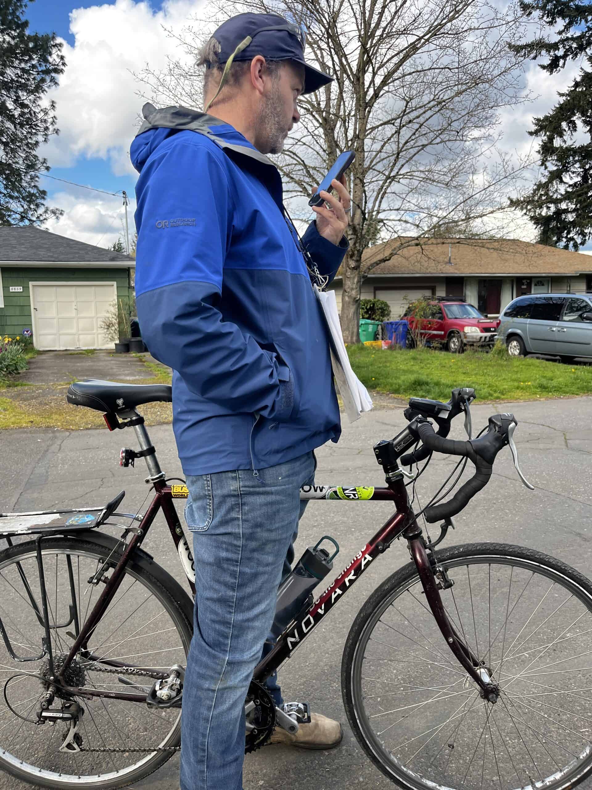 Kol Peterson on the phone with a Cully resident who inquired about utilities for a mobile dwelling. Photo by Catie Gould. 