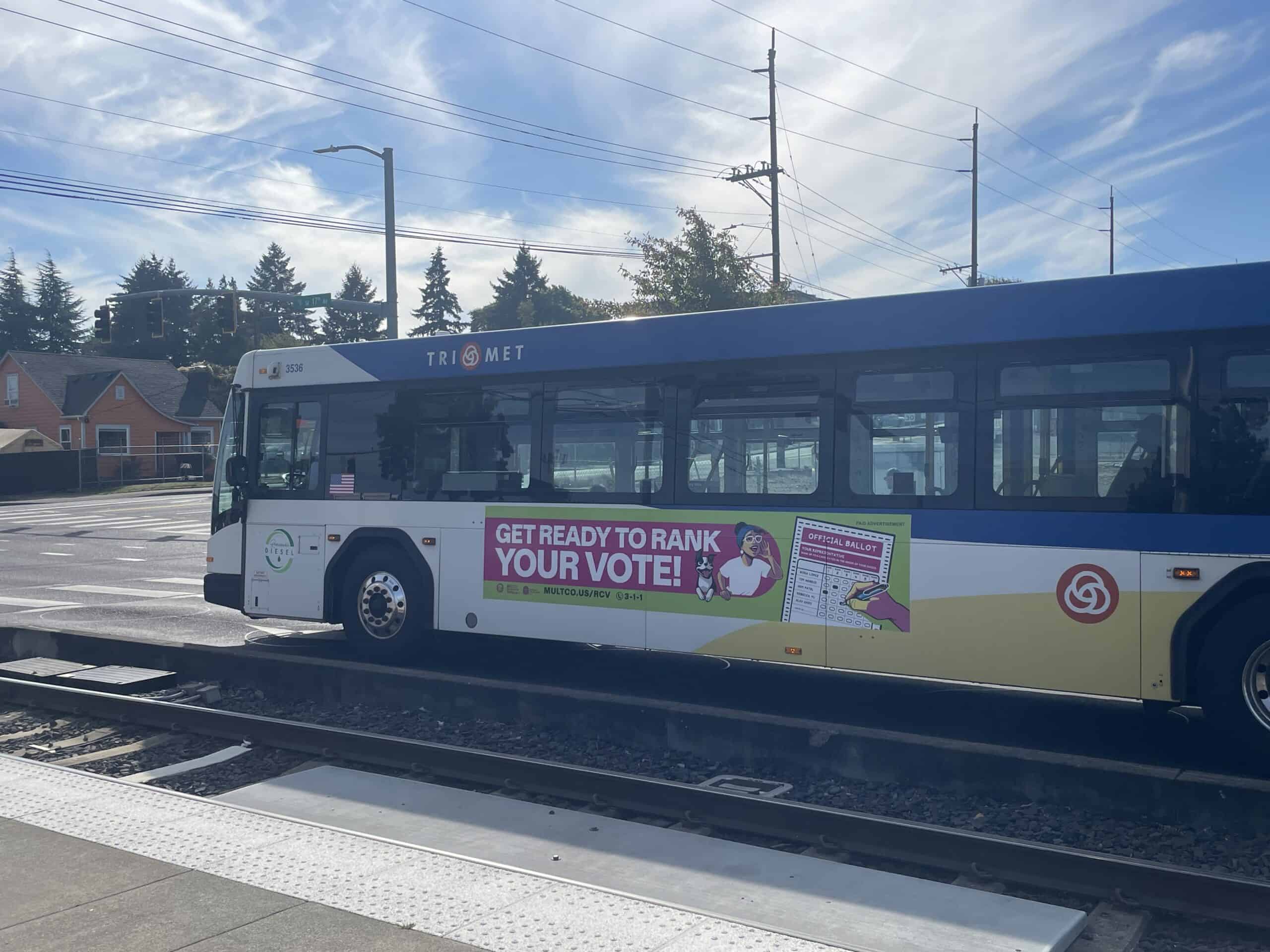 A TriMet bus in Portland carrying a Multnomah County ranked choice voting ad, September 2026. Photo by Kelly Trumbull.