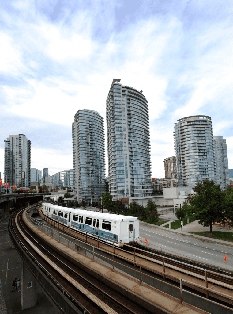 Apartment homes near the Stadium-Chinatown SkyTrain station in Vancouver, BC, from 2013. The Vancouver Metro region has followed transit-oriented development principles for 50 years. Photo by Tim Adams, via Wikimedia commons.  